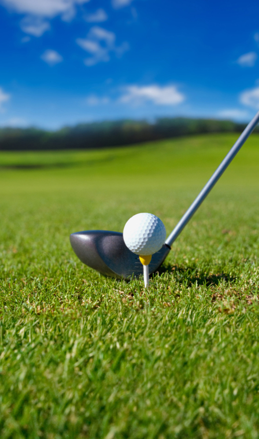 Golf club with ball on tee on blue sky